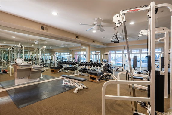 Indoor gym area with exercise machines and weights.