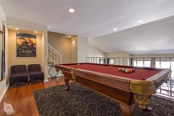 Room with a pool table and seating area.