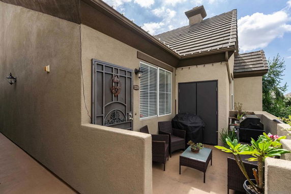 Front view of a house with a small patio area.