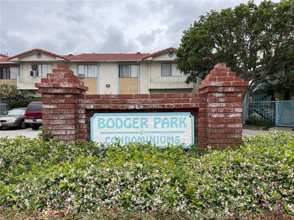 Front view of a condominium complex with a brick signage reading 'Bodger Park Condominiums'.