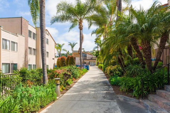 Pathway with garden and residential buildings.