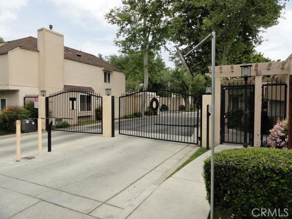 Front view of a two-story building with a gated entrance.