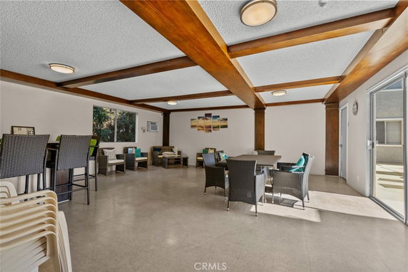 Interior view of a clubhouse with seating and tables.