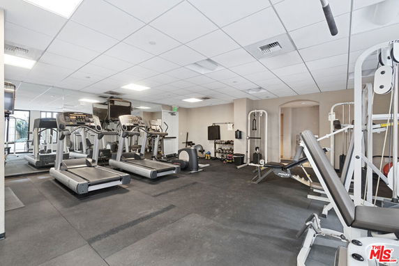 Indoor gym area with exercise equipment and treadmills.
