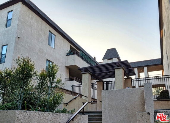 Front view of a multi-story residential building with a modern design.
