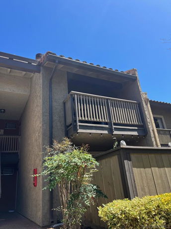 Front view of a building with a small balcony.