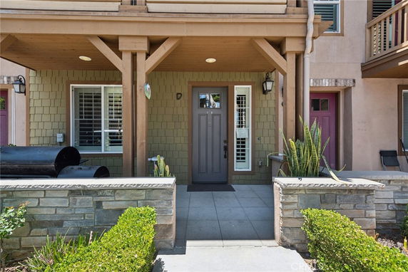 Front view of a house with a covered entryway and a single door.