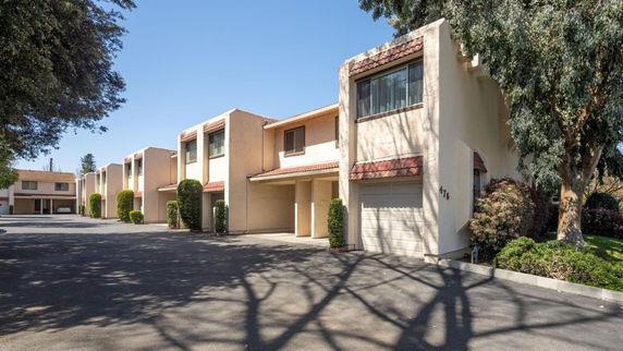 Front view of a two-story townhouse with a garage.