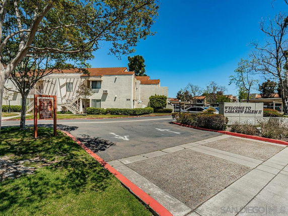 Front view of a residential building complex with multiple units and a sign reading 'Welcome to Casa New Salem II.'