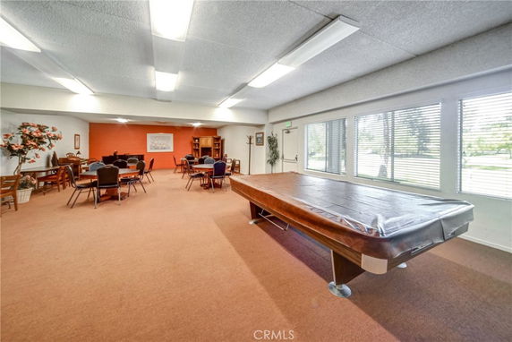 Indoor recreational area with a billiards table and seating