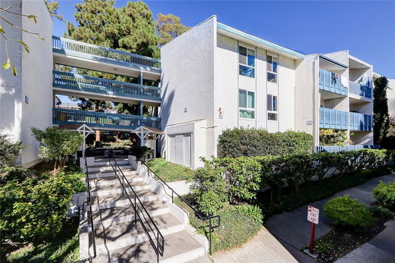 Front view of a multi-story residential building with balconies.