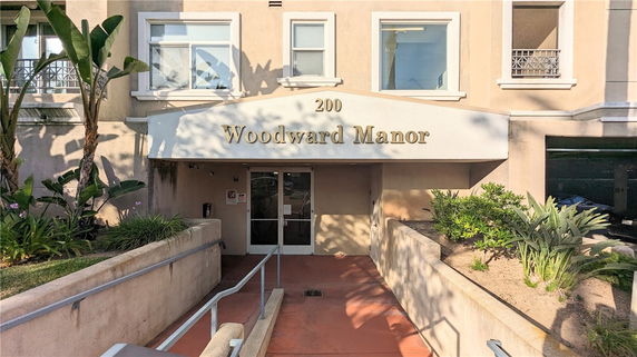Front view of a building with the name 'Woodward Manor' and multiple windows.