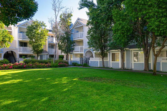 Front view of a multi-story residential building with balconies.