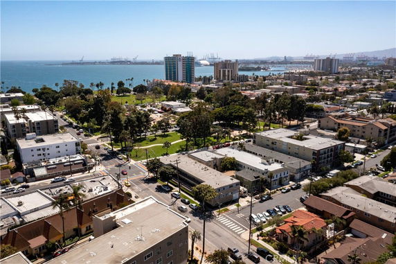 Panoramic view of a coastal city with buildings and ocean.