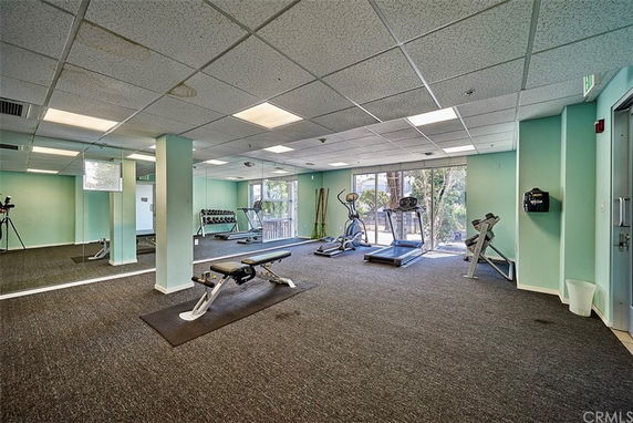 Interior view of a gym area with exercise equipment in a clubhouse setting.