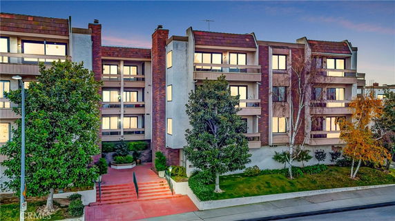 Front view of a multi-story residential building with balconies.