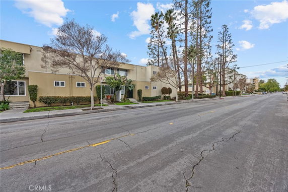 Front view of a two-story apartment building with a flat roof and small windows.