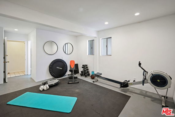 Indoor gym area with exercise equipment in a home.