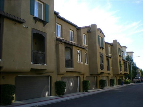 Front view of a multi-story residential building with garages.