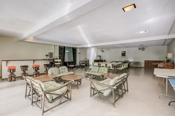 Interior view of a recreation room with seating and tables.