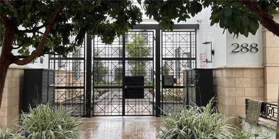 Front view of a gated entrance with a metal gate and building number 288.