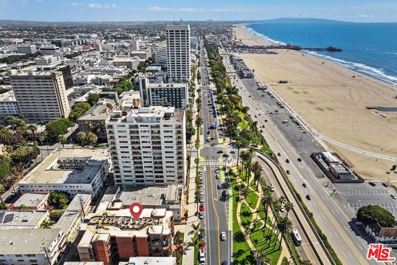 Aerial view of a city coastline with high-rise buildings near a beach.