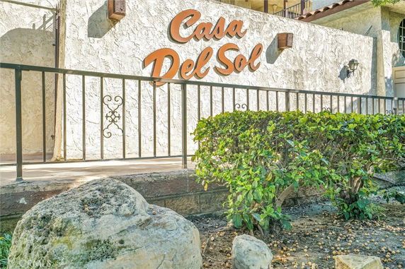 Front view of a building with decorative signage on a textured wall.
