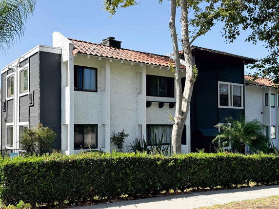 Front view of a two-story residential building with a tiled roof.