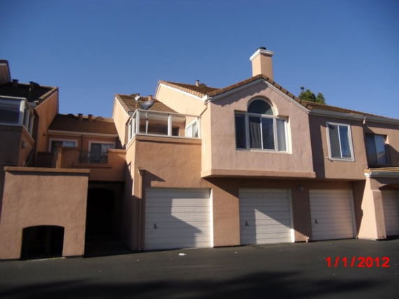 Front view of a multi-story house with attached garages.