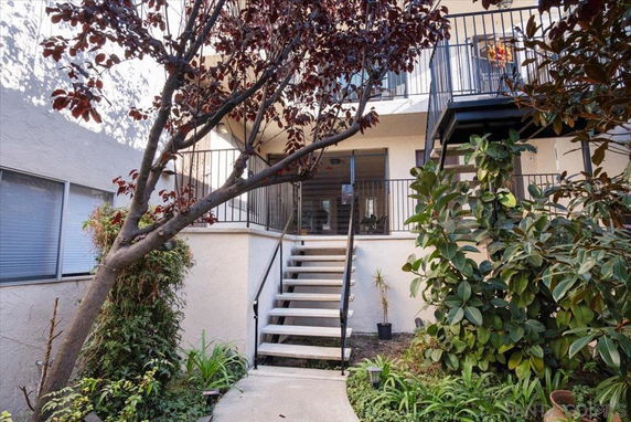 Front view of a building with stairs leading to the entrance.