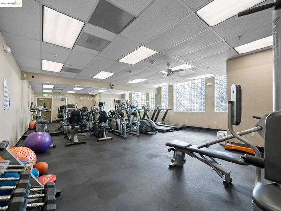 Interior view of a gym with exercise machines and equipment.