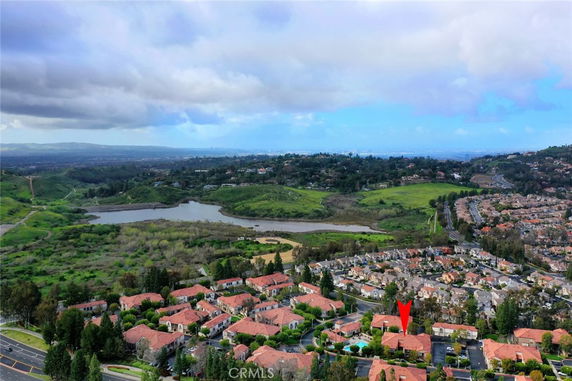 Panoramic view of residential area with surrounding landscapes and a lake.