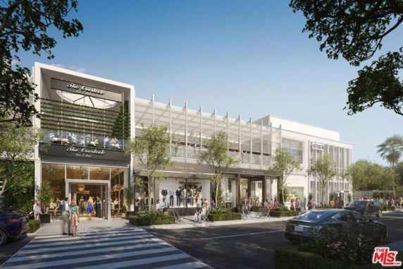Front view of a modern commercial building with multiple stores and large glass windows.