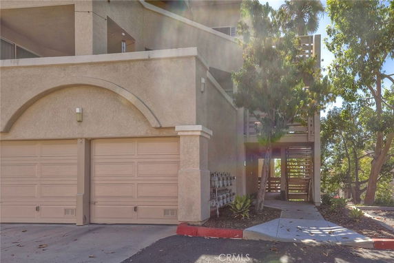 Front view of a multi-story building with a double garage.