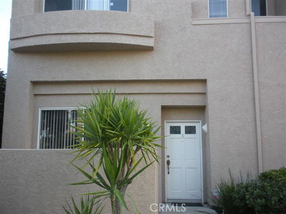 Front view of a house with a white door and two-story structure.