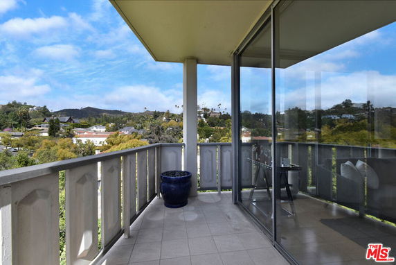 Balcony view with surrounding landscape and hills visible