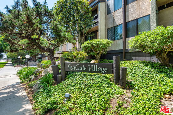 Front view of a residential building with a sign reading 'SeaGate Village'.