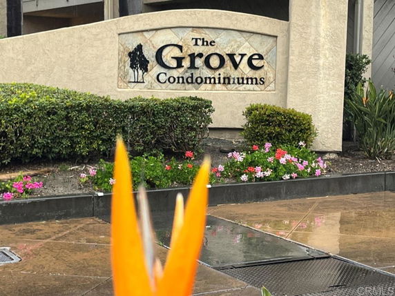 Entrance view of a condominium complex with a sign reading 'The Grove Condominiums'.