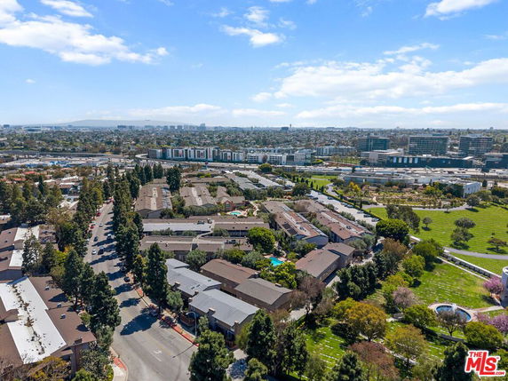 Panoramic view of a residential area with surrounding buildings and greenery.