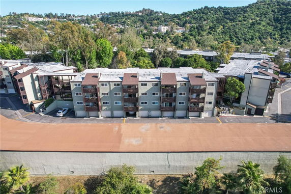 Front view of a multi-story apartment building with several balconies.