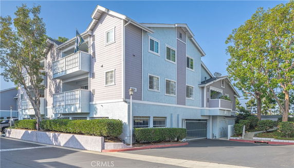 Front view of a multi-story residential building with balconies.