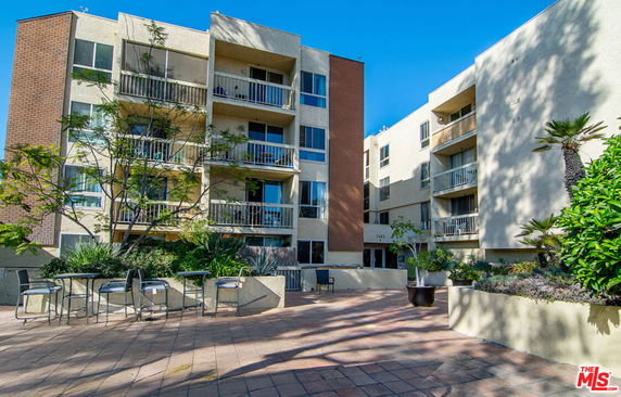 Front view of a multi-story residential building with balconies.