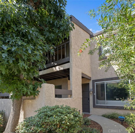 Front view of a two-story house with a balcony.