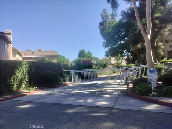 Front view of residential buildings with gated entrance.