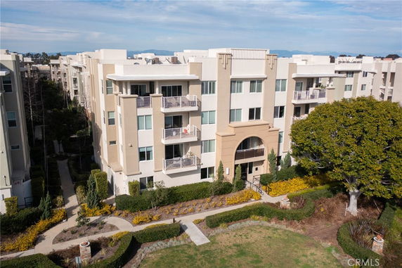 Front view of a multi-story apartment building with balconies.