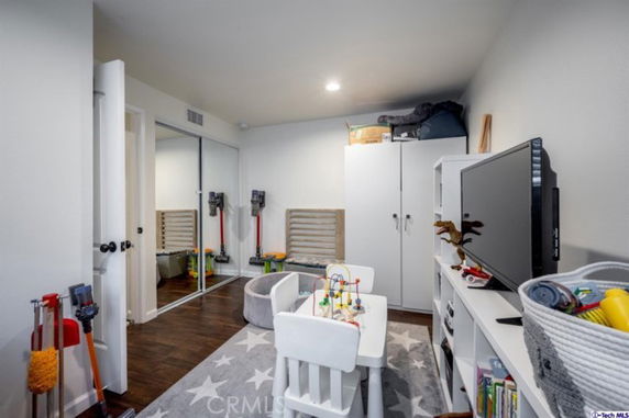 Indoor play area with toys, small table, and storage cabinets.