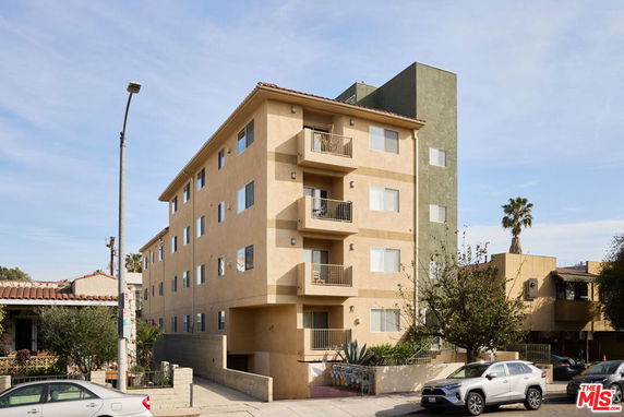 Front view of a multi-story residential building with balconies.