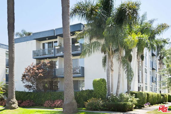 Front view of a multi-story residential building with balconies.