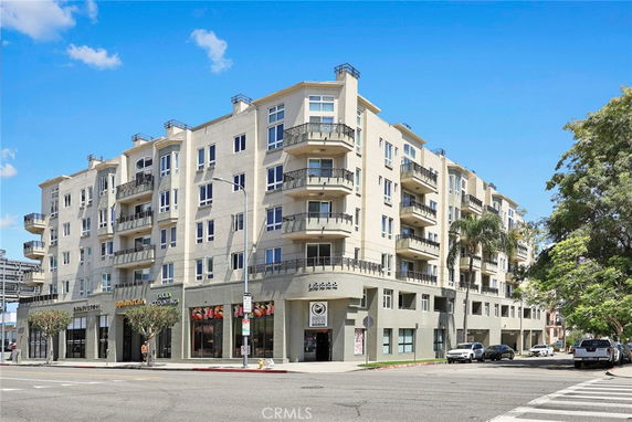 Front view of a multi-story residential building with balconies.