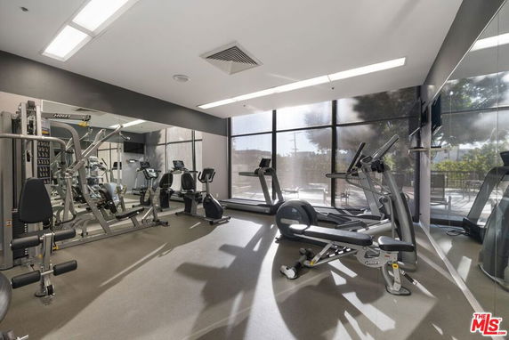 Interior view of a modern gym area with exercise equipment.